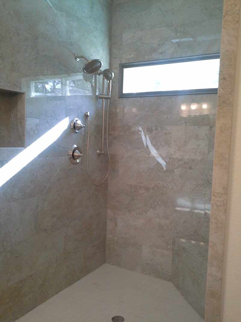 Tile shower, natural lighting and glass enclosure