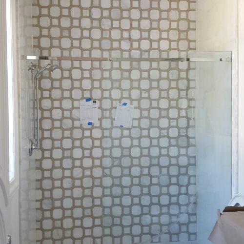 Patterned tile shower with glass door
