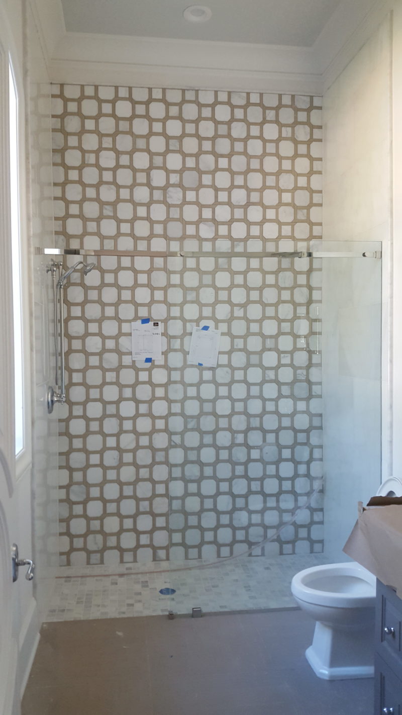 Patterned tile shower with glass door